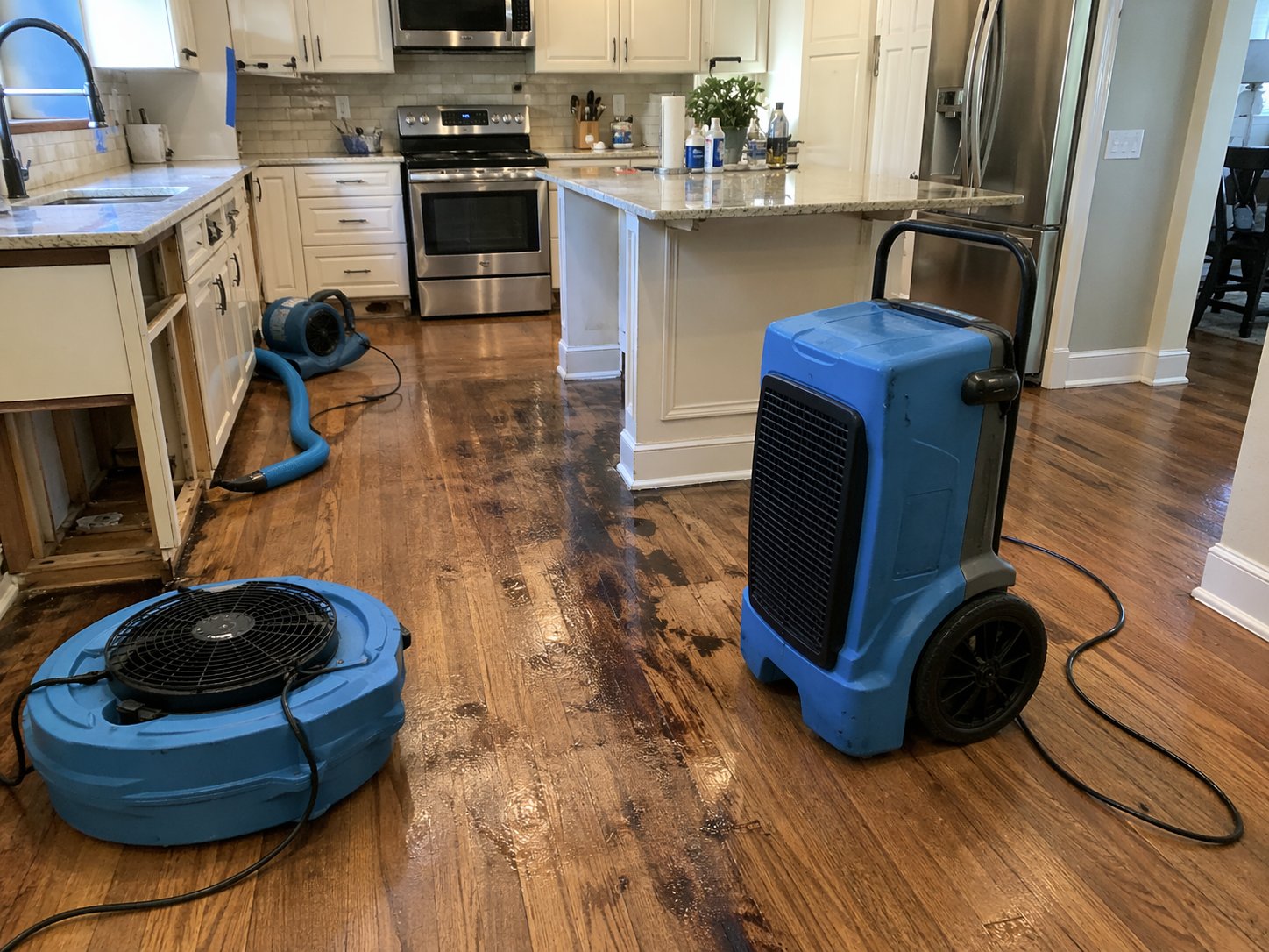 Water damage restoration equipment drying a flooded kitchen in Dallas-Fort Worth